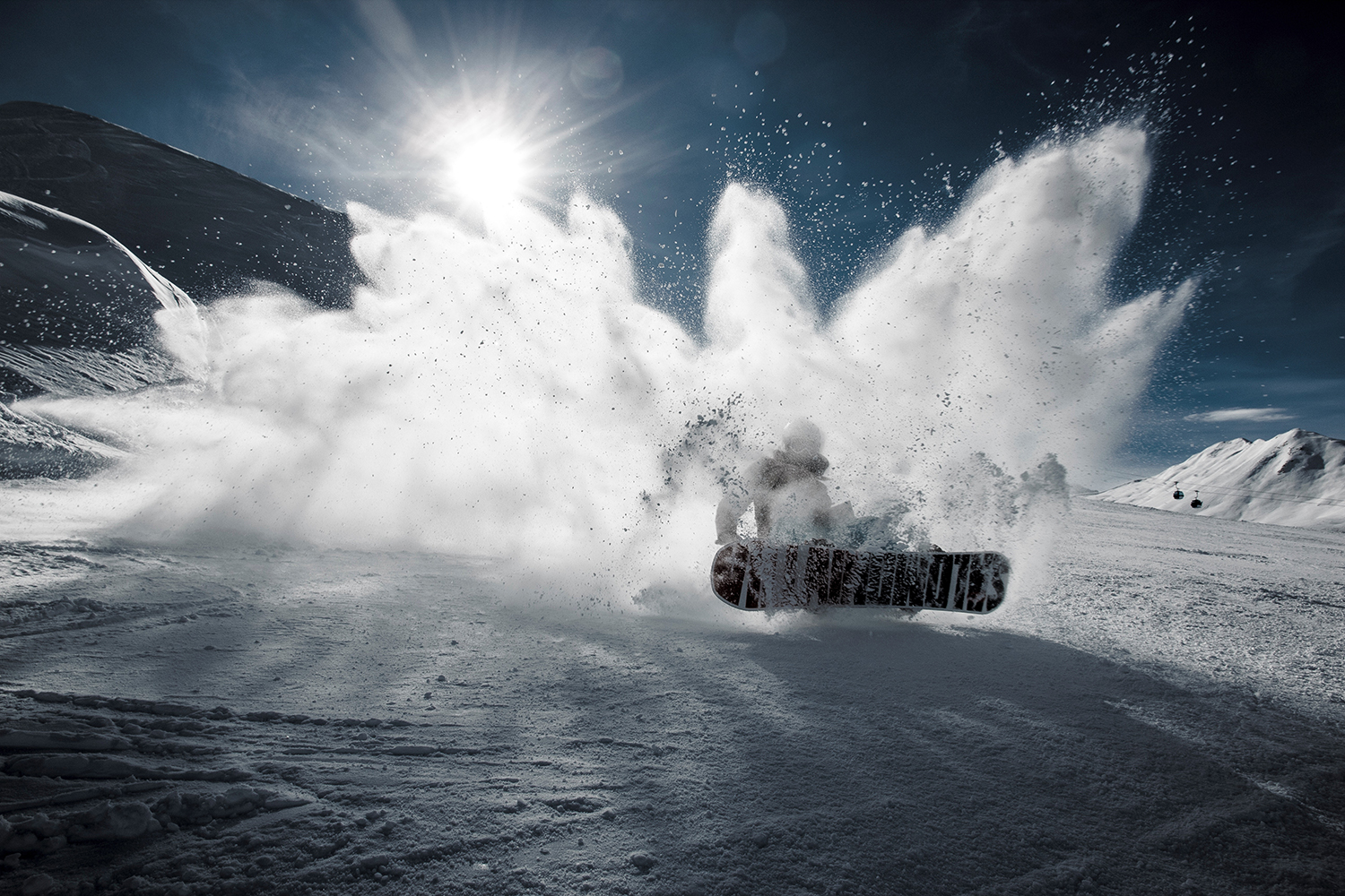 Snowboarder spraying powder