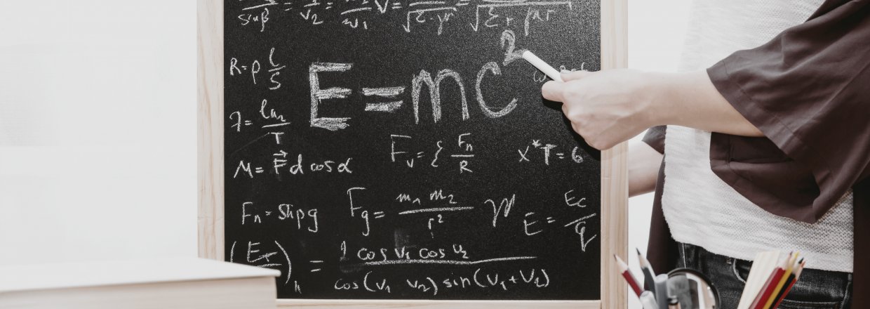 Image of a chalk board with mathematical equations on it