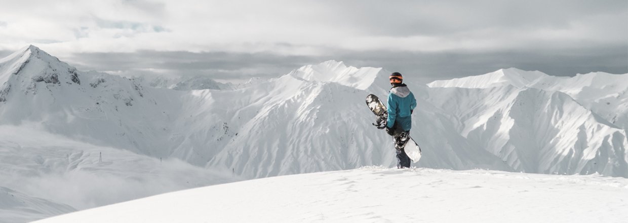 snowboarder staring at the mountains